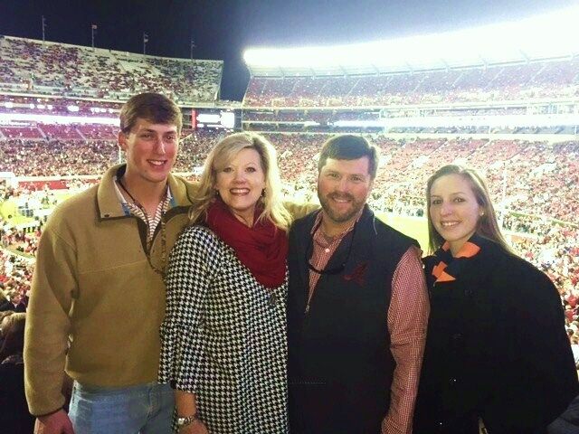 Kerry and Shanna Holt holding a framed photo of their daughter Caroline