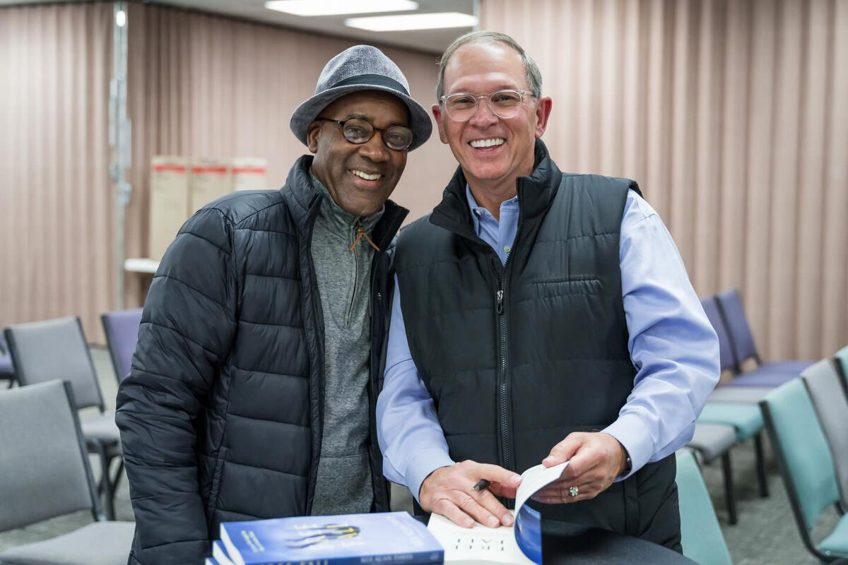 Rex Davis signing a copy of Free Fall for a reader